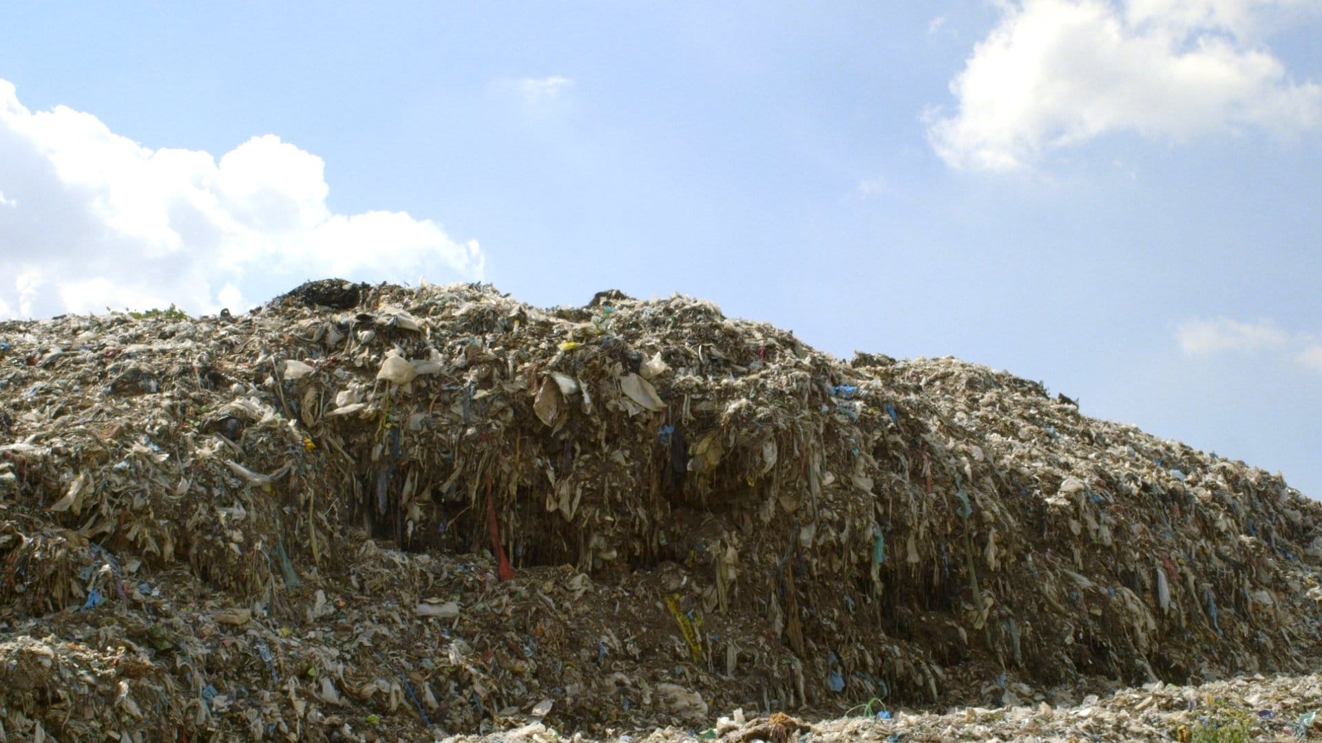 Scraps of clothes sitting in landfills.