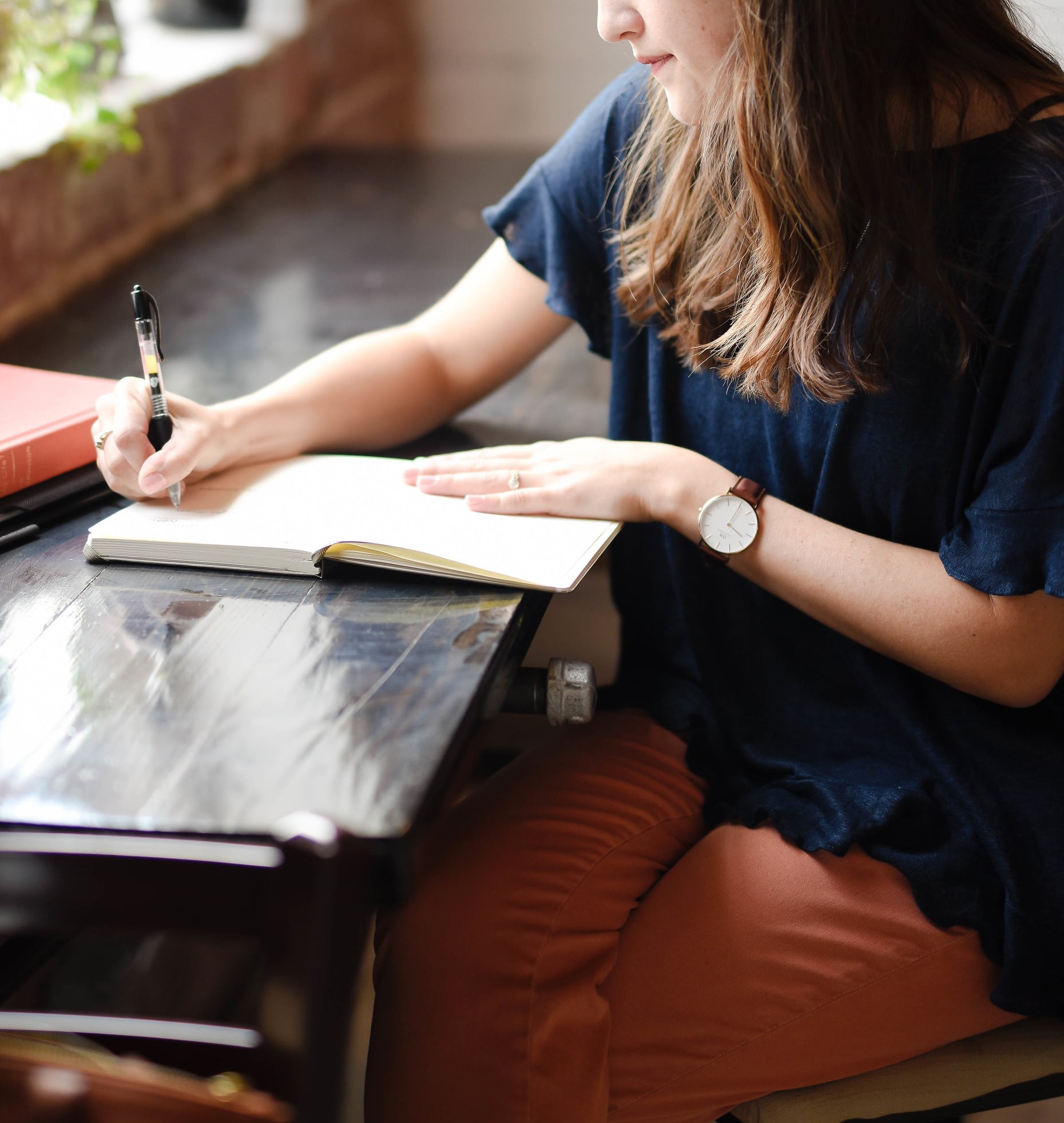 A woman writing a letter to a company about their packaging and sustainability.